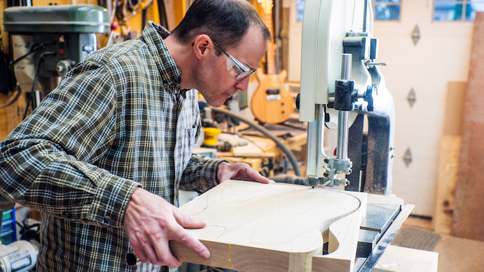 Custom Guitar Atelier luthier developing a custom guitar design at the drawing board